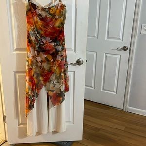 Cache white with print sleeveless jumpsuit comes with a red cardigan